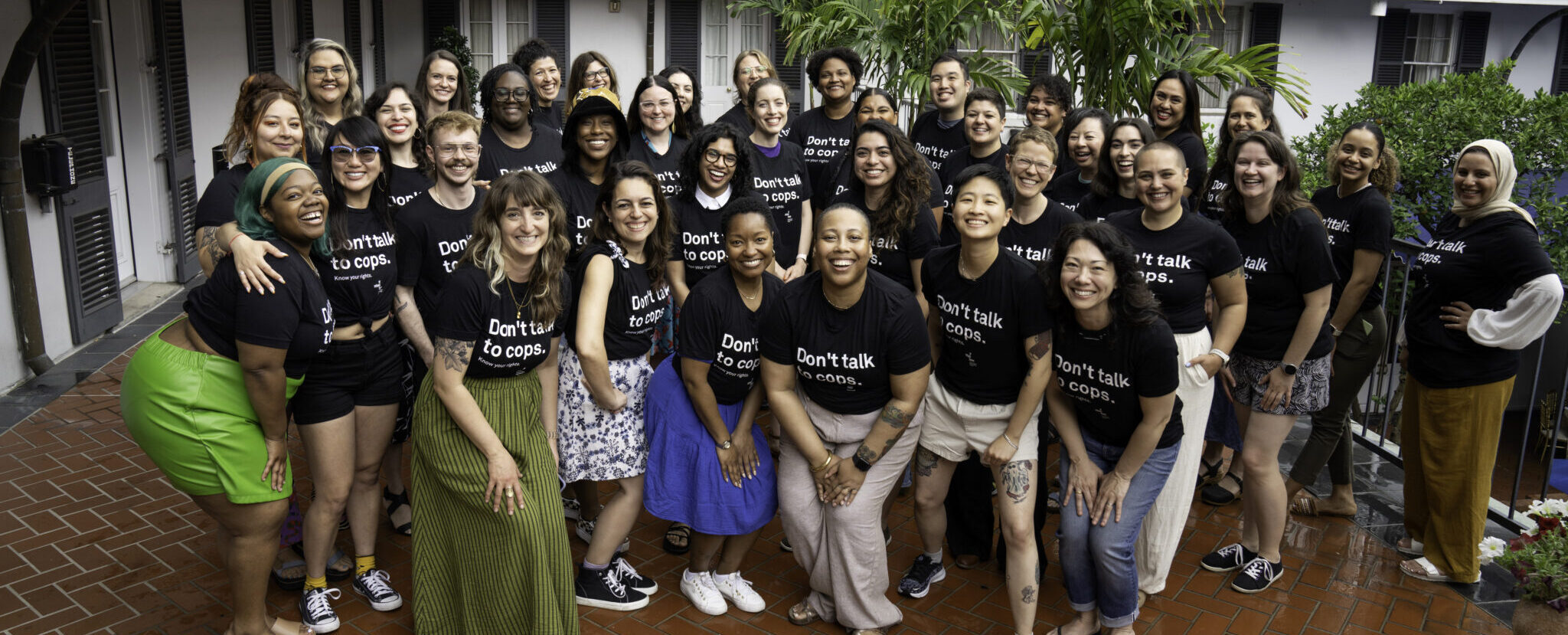 Photo of If/When/How staff, outside wearing "Don't Talk to Cops" t-shirts.